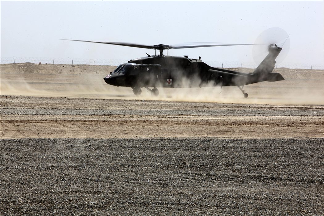 UH-60 Black Hawk medevac helicopter landing at desert casualty evacuation point